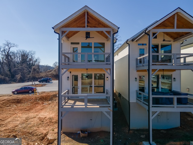 rear view of property featuring a balcony