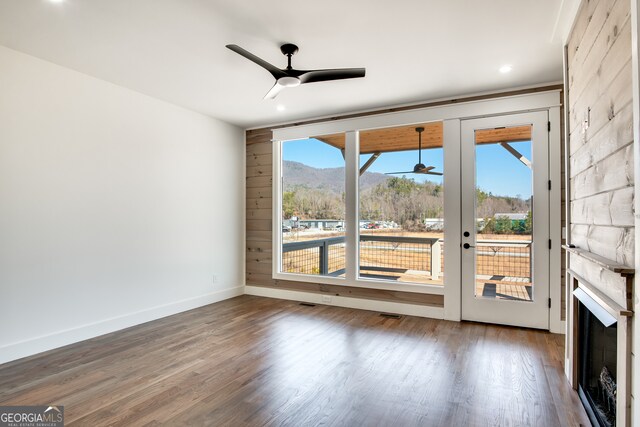 unfurnished room featuring ceiling fan, dark hardwood / wood-style floors, and french doors