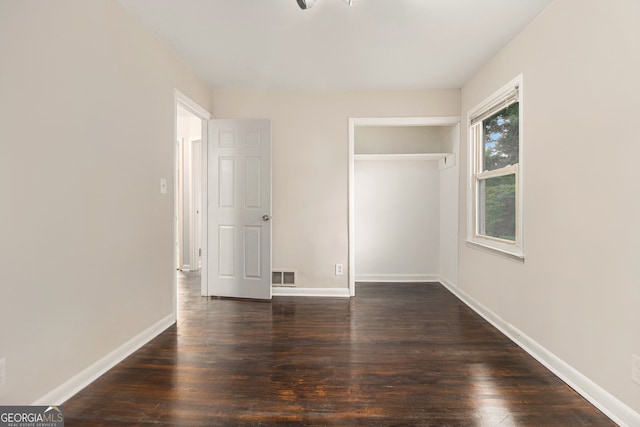 unfurnished bedroom featuring dark wood-type flooring