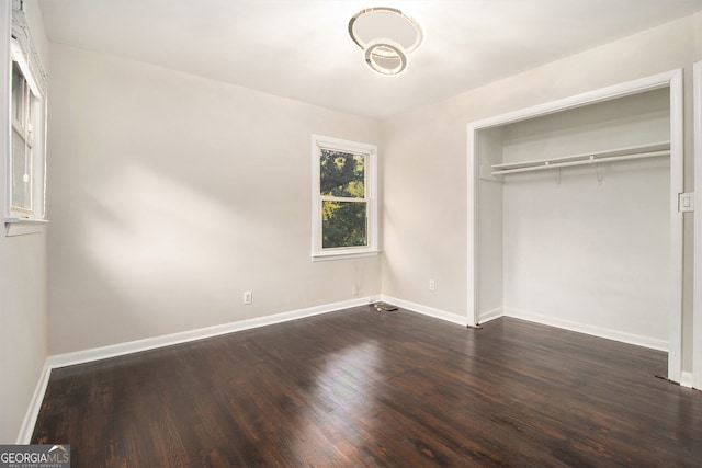 unfurnished bedroom featuring hardwood / wood-style flooring and a closet