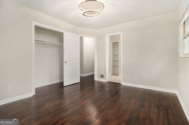 unfurnished bedroom with a closet and hardwood / wood-style floors