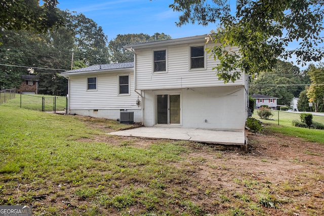 rear view of property featuring a patio area, a yard, and central AC