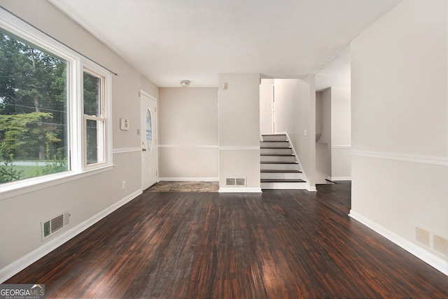 spare room with a wealth of natural light and wood-type flooring