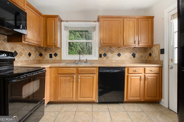 kitchen featuring sink, decorative backsplash, and black appliances