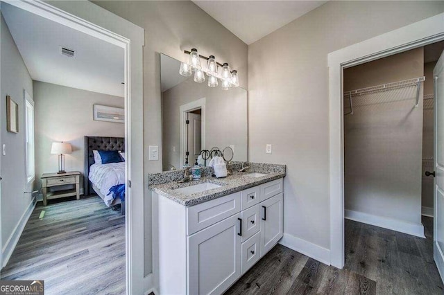 bathroom with hardwood / wood-style flooring and double sink vanity