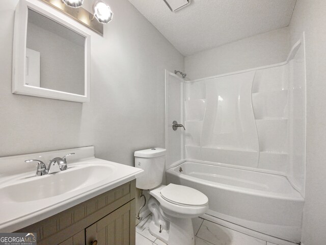 full bathroom featuring toilet,  shower combination, a textured ceiling, tile floors, and vanity