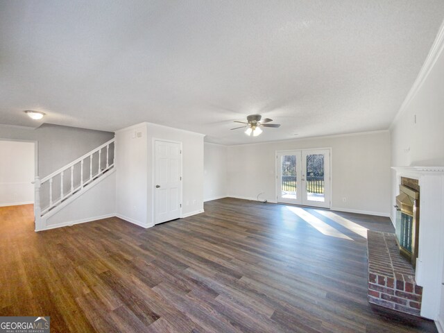 unfurnished living room featuring crown molding, dark hardwood / wood-style flooring, and a brick fireplace