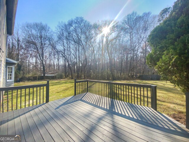 wooden terrace with a yard