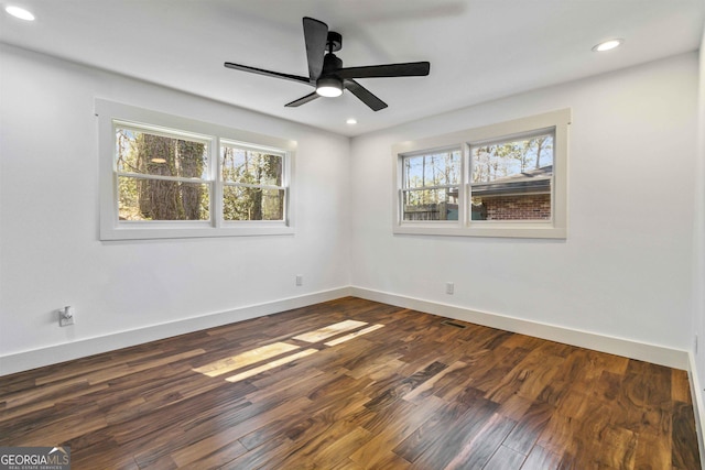 empty room featuring ceiling fan and dark hardwood / wood-style flooring