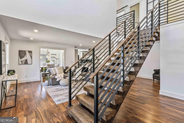 stairway featuring wood-type flooring