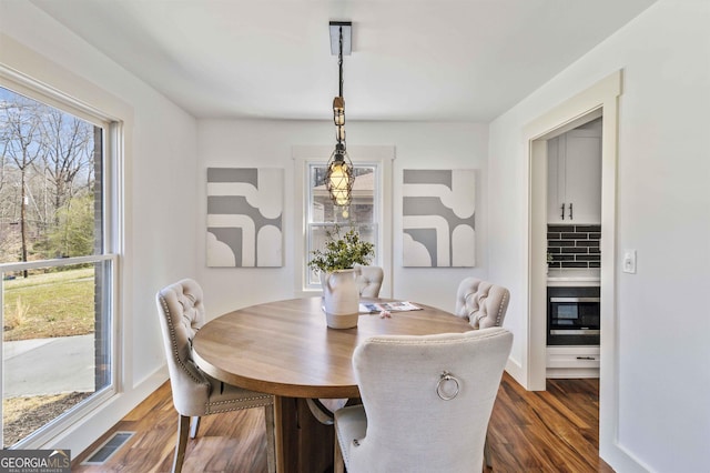 dining area featuring dark hardwood / wood-style floors