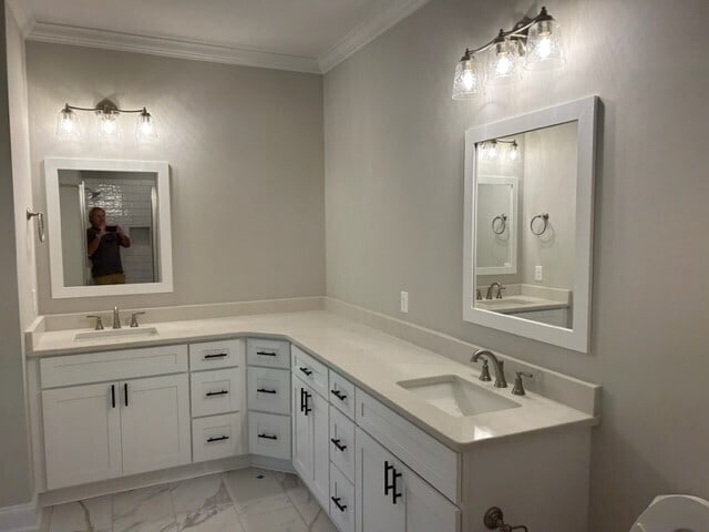 bathroom featuring crown molding, tile floors, and double vanity