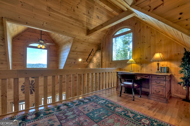 office featuring hardwood / wood-style flooring, lofted ceiling with beams, and plenty of natural light