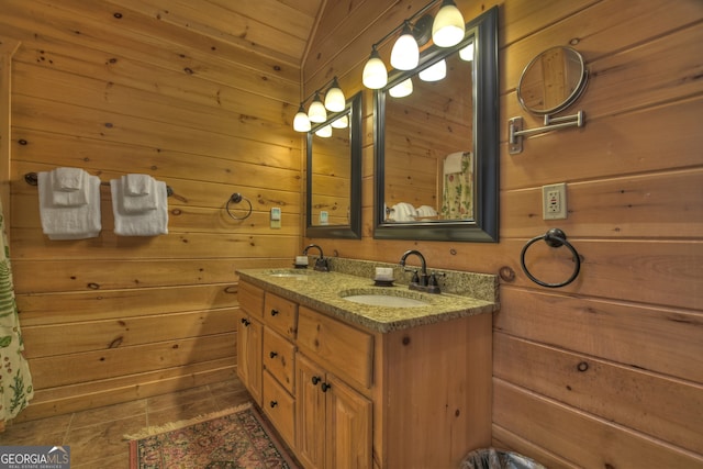 bathroom featuring vanity and wood walls