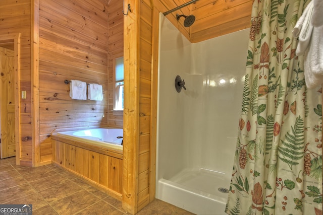 bathroom with shower with separate bathtub, wooden walls, and tile patterned floors