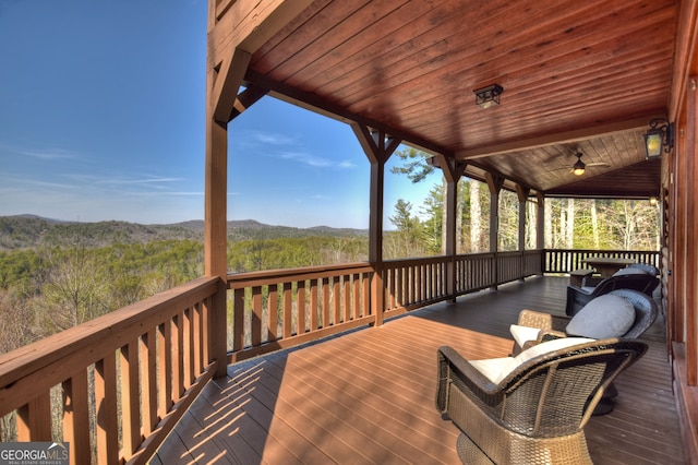 wooden deck featuring ceiling fan