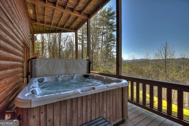 wooden terrace with a hot tub