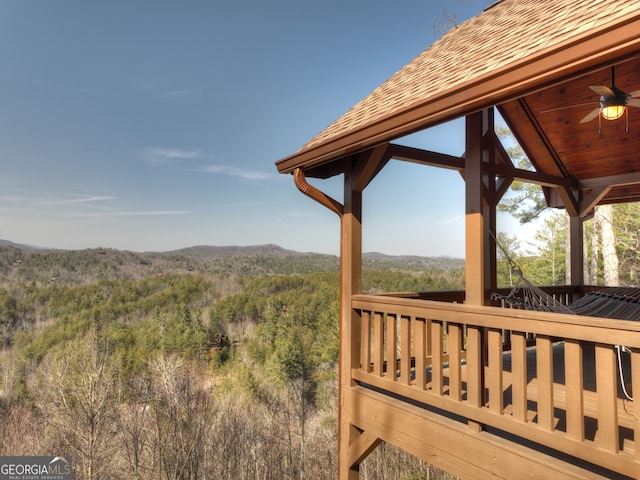 wooden deck featuring a gazebo and ceiling fan