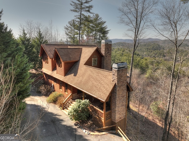 view of side of home with a mountain view