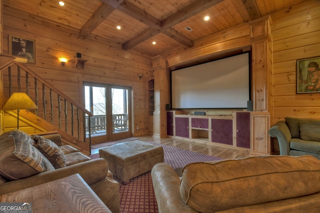 home theater featuring wood walls, french doors, hardwood / wood-style floors, beamed ceiling, and wooden ceiling