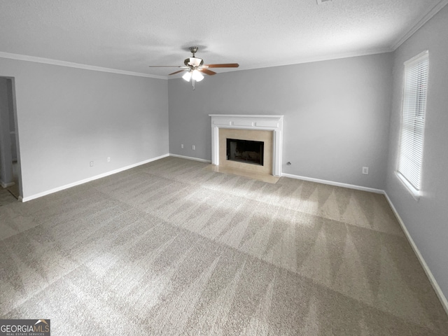 unfurnished living room with crown molding, ceiling fan, light carpet, and a textured ceiling