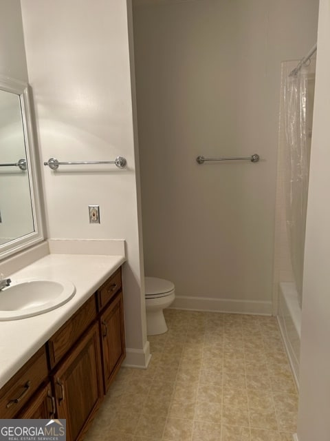 full bathroom featuring vanity, shower / tub combo, and toilet