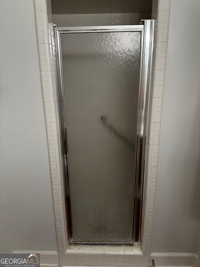 bathroom with a shower with shower door