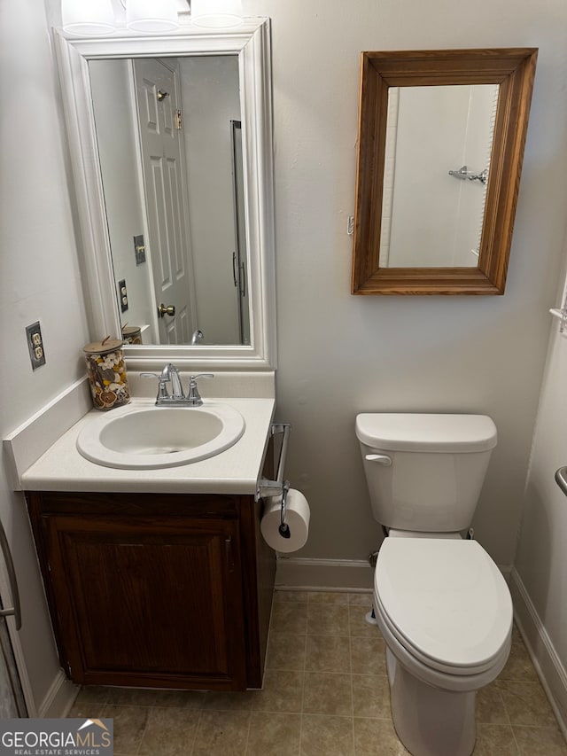 bathroom with vanity, toilet, and tile patterned flooring