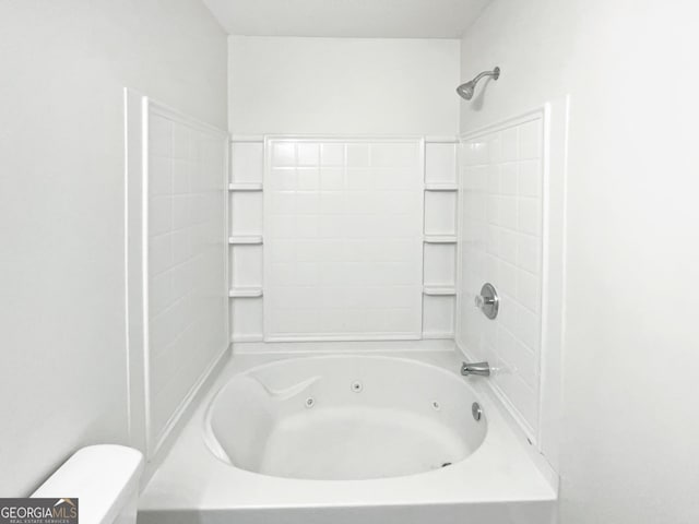 bathroom with a combined bath / shower with jetted tub and toilet