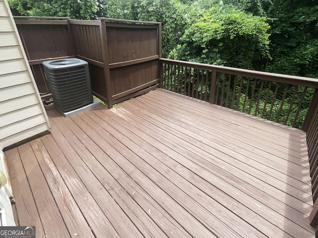 wooden deck featuring central air condition unit