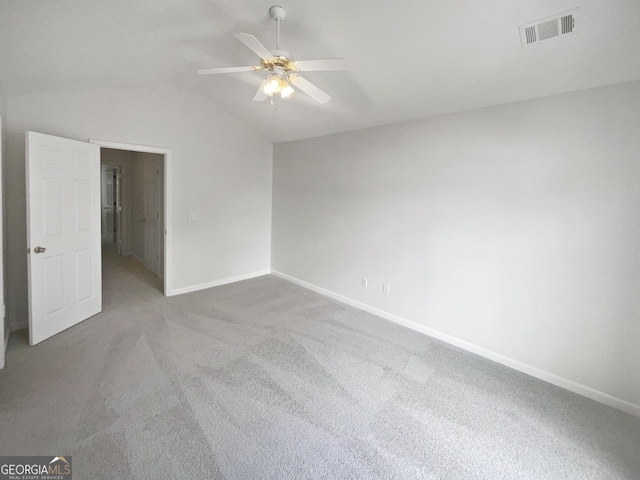 carpeted empty room featuring ceiling fan and lofted ceiling