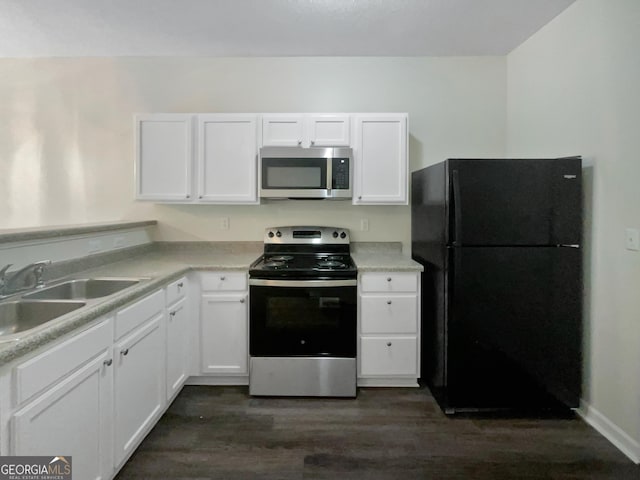kitchen with a sink, appliances with stainless steel finishes, and white cabinets