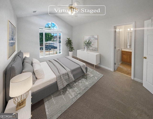 carpeted bedroom with vaulted ceiling, ensuite bath, and ceiling fan