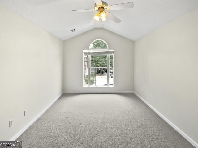 unfurnished room featuring a ceiling fan, baseboards, vaulted ceiling, and carpet