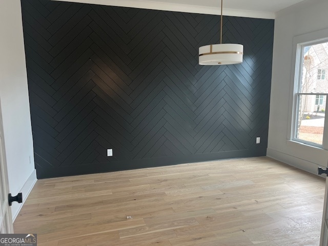 spare room featuring light hardwood / wood-style flooring and a wealth of natural light