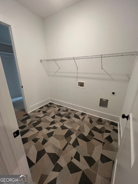 clothes washing area with hookup for an electric dryer, dark tile flooring, and washer hookup