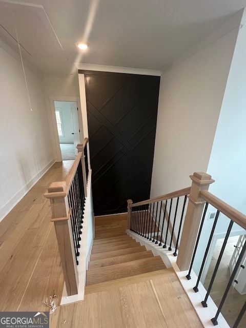 stairs featuring light wood-type flooring