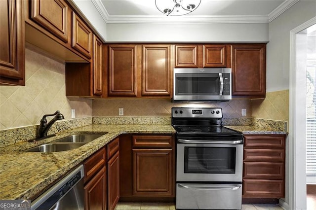 kitchen featuring a healthy amount of sunlight, sink, appliances with stainless steel finishes, and tasteful backsplash