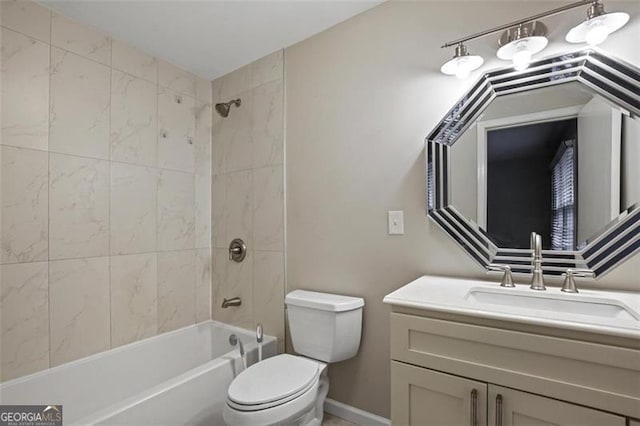 full bathroom featuring tiled shower / bath, toilet, and vanity