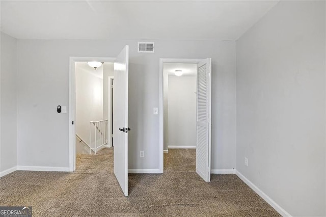 unfurnished bedroom with a closet and carpet flooring