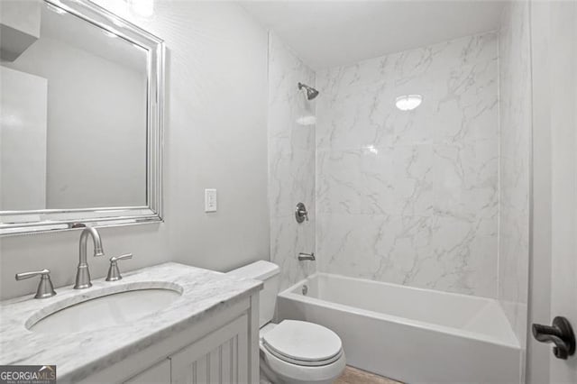 full bathroom featuring toilet, tiled shower / bath combo, and vanity