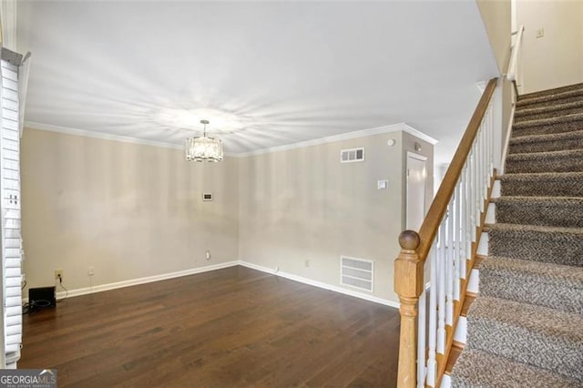 interior space with crown molding, an inviting chandelier, and dark hardwood / wood-style floors