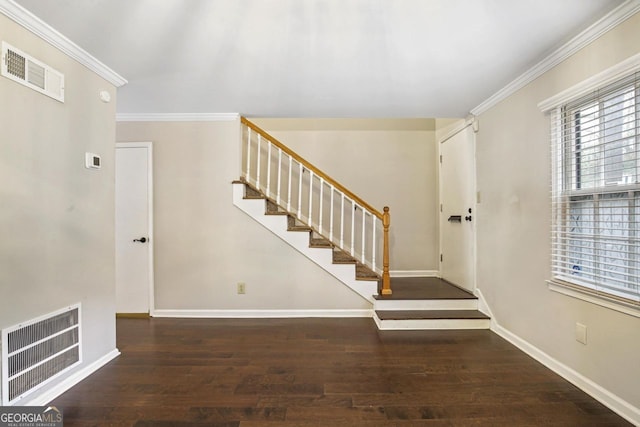 entryway featuring ornamental molding and dark hardwood / wood-style floors