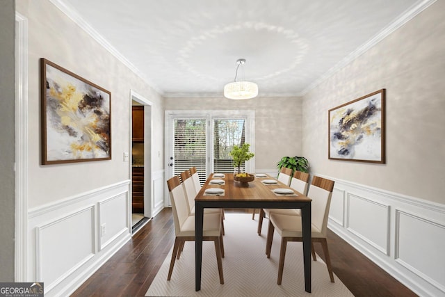 dining room featuring ornamental molding and dark hardwood / wood-style flooring