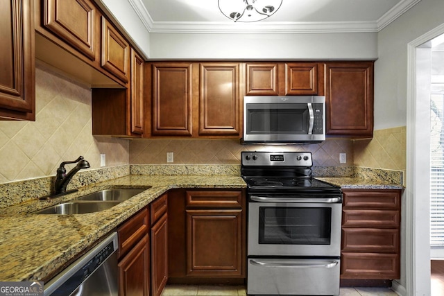 kitchen featuring ornamental molding, stainless steel appliances, light stone counters, sink, and decorative backsplash