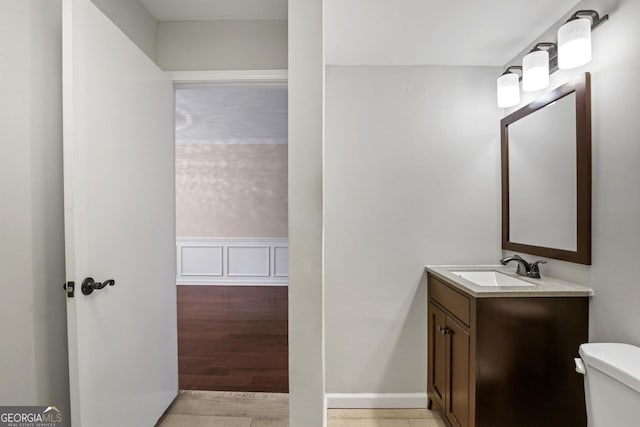 bathroom featuring hardwood / wood-style floors, toilet, and vanity