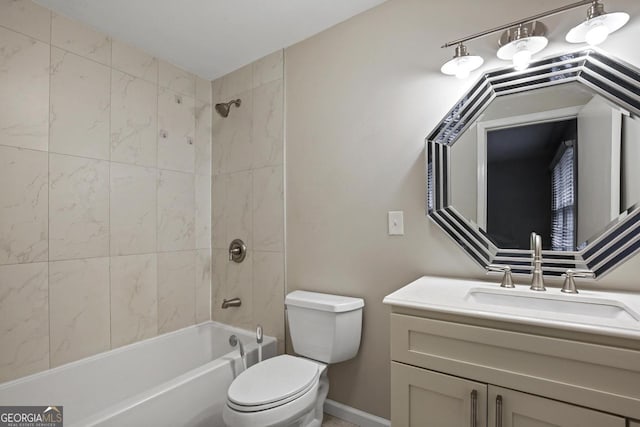 full bathroom with tiled shower / bath, toilet, and vanity