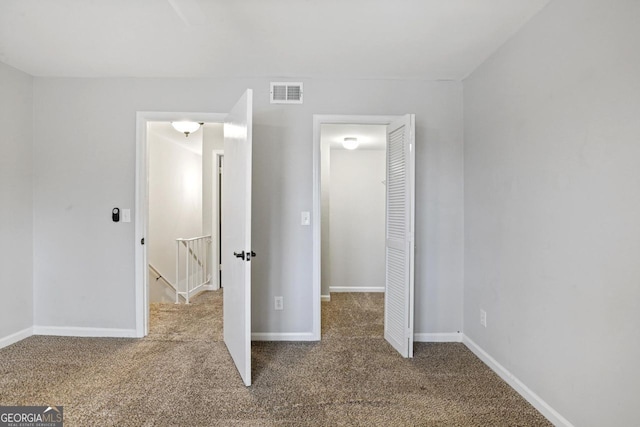 unfurnished bedroom with a closet and carpet flooring