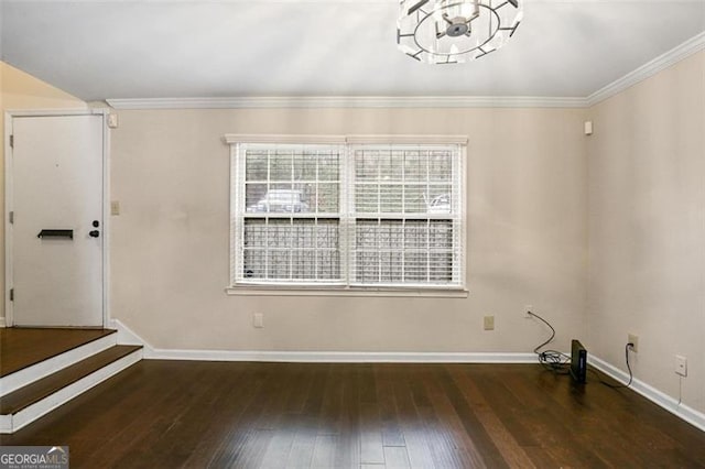 empty room with ornamental molding and dark hardwood / wood-style flooring