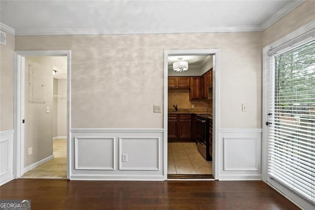 unfurnished dining area with ornamental molding, dark wood-type flooring, and sink